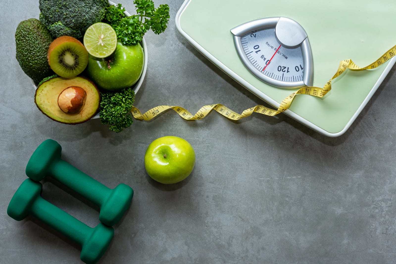 Exilis | A photo of healthy food, weights, and a scale for a healthy lifestyle