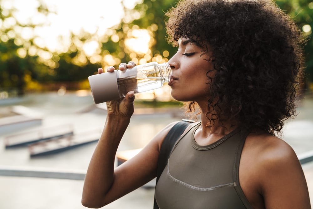 Exilis | A photo of a fit young woman drinking water