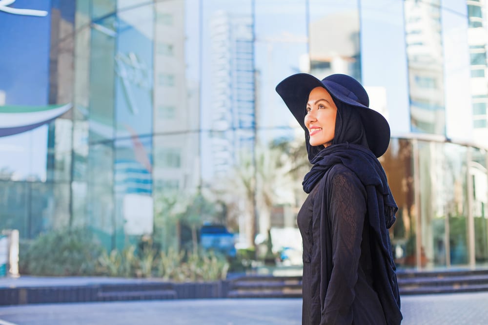 Melasma | A muslim woman wearing a hijab and a hat to protect her skin from the sun.