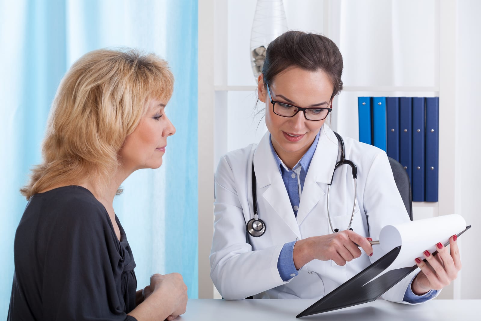 A woman having a medical consultation with a female doctor